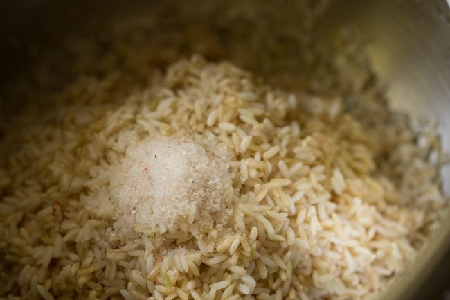 soaked rice added to pressure cooker with salt