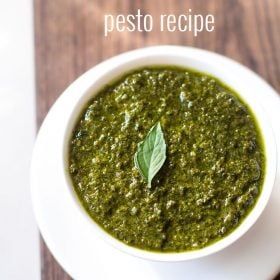 pesto sauce in a white bowl with white text layovers.